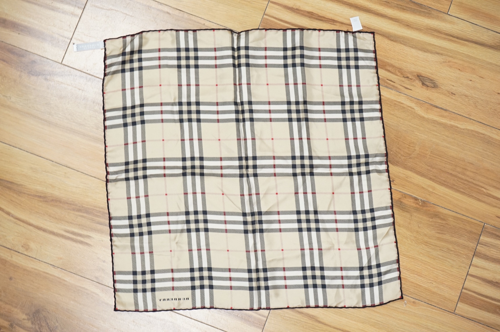 Three silk scarves comprising a Burberry check example, Christian Dior monogrammed and a Vakko abstract patterned example